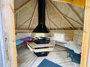 a room with a stove in the middle of a cabin at Holiday home Koppom in Koppom