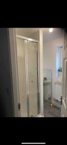 a bathroom with a shower and a toilet at Loving Home to Stay with Rear Garden and Patio in Rochdale