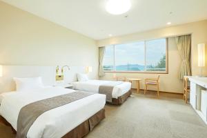 Postel nebo postele na pokoji v ubytování KAMENOI HOTEL Fukui