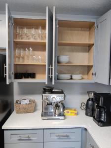 a kitchen counter with a coffee maker and glasses at Roosevelt Inn in Jacksonville