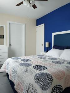 1 dormitorio con 1 cama con pared azul en Departamento moderno en Ciudad Juárez