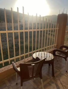 a balcony with a table and chairs and a view at شقق السودة هاوس in Suda