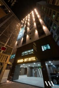 a tall building with a clock on top of it at Seomyeon Brown-dot hotel Gold in Busan