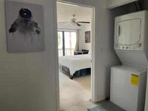 a bedroom with a bed and a tv in a room at Hello Sunshine 321... Lift Off in Titusville