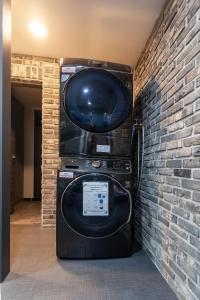 a large television in a room with a brick wall at Seomyeon Brown-dot hotel Gold in Busan