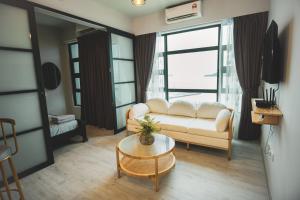 a living room with a couch and a table at TF Sunset Ocean View Homestay - Jesselton Quay in Kota Kinabalu
