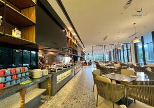 a restaurant with tables and chairs and a cafeteria at Bahang Bay Hotel in Batu Ferringhi +54 photos