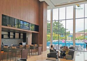 two people sitting at a bar in a hotel lobby at Bahang Bay Hotel in Batu Ferringhi