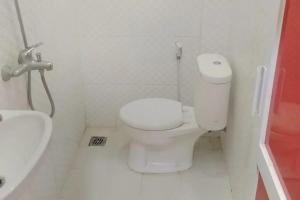 a bathroom with a white toilet and a sink at Urbanview Syariah Utami Inn Garut by RedDoorz in Garut