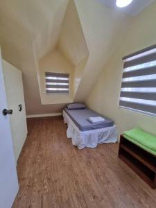 a attic room with a bed and a window at #30 Bel Air House by Red Door House Rental in Santa Rosa +46 photos