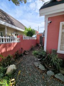 a red house with a fence next to a yard at #30 Bel Air House by Red Door House Rental in Santa Rosa