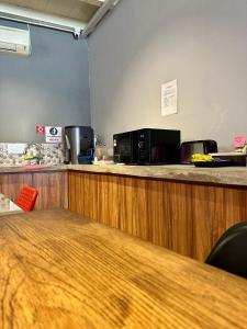 an office with a counter with a microwave and a table at Swing & Pillows @ Beach Street in George Town