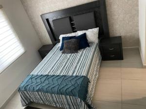 a bedroom with a large bed with blue pillows at Casa Mauricio in La Paz