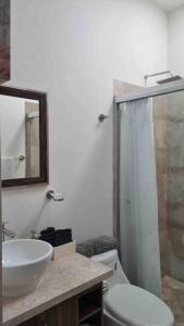 a bathroom with a sink and a toilet and a mirror at Casa Mauricio in La Paz +29 photos