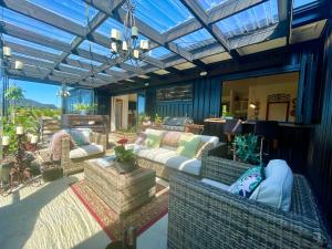 a conservatory with couches and chairs on a patio at Ballygelvar in Cambridge