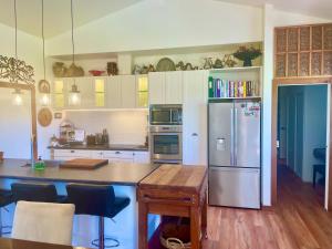 a kitchen with a stainless steel refrigerator and a table at Ballygelvar in Cambridge