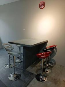 a barber shop with stools around a black counter at Impian Stay 0.1 Townhouse with 3 bedrooms. in Kuah