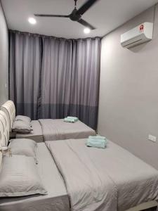 a room with three beds and a ceiling fan at Impian Stay 0.1 Townhouse with 3 bedrooms. in Kuah +11 photos
