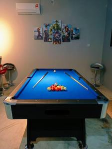 a blue pool table with balls on top of it at Impian Stay 0.1 Townhouse with 3 bedrooms. in Kuah