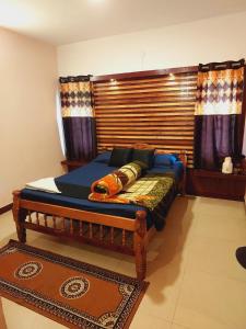 a bedroom with a bed with a wooden headboard at IMPERIAL COTTAGE, HILL BUNK OOTY in Ooty