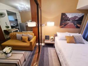 a bedroom with a large bed and a chair at Staycation by Ness in Ayala Makati in Manila +28 photos