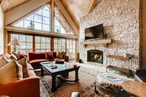 a large living room with a stone wall at 1-Vail Mountain View 403 in Vail