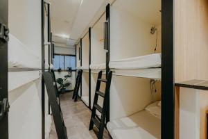 a row of bunk beds in a dorm room at unito light SHIMBASHI in Tokyo