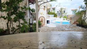 a stone walkway leading to a house with a pool at Room in Apartment - Spacious Room in Creta for 3 people, with Ac, Swimming Pool and Nature in Hersonissos