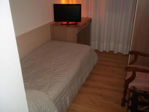 a bedroom with a bed and a television at Hotel Gronda Lagunare in Tessera