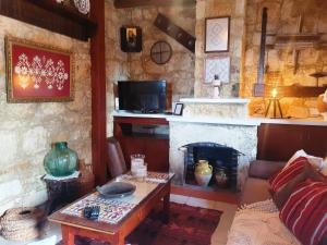 a living room with a couch and a fireplace at HideAway Lasa in Lasa