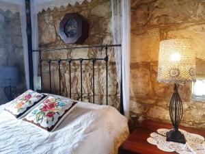 a bedroom with a bed and a table with a lamp at HideAway Lasa in Lasa