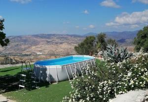 a swimming pool in a yard with a hill at HideAway Lasa in Lasa