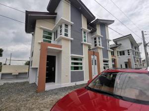 a red car parked in front of a house at JRLB PLACE - Accommodation in Concepcion, Tarlac in Concepcion