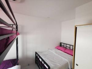 a bedroom with a bunk bed with pink pillows at JRLB PLACE - Accommodation in Concepcion, Tarlac in Concepcion +19 photos