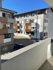 a car parked in a parking lot in front of buildings at Tiberiu Ricci Apartament in Sibiu