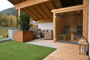 an outdoor patio with a couch and a table at Residence Haus Martha in Biberwier