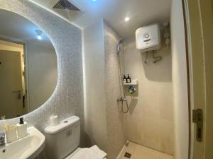 a bathroom with a sink and a toilet and a mirror at Camaya at tanglin apartement in Lontar +54 photos