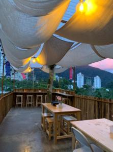 a patio with tables and chairs under a tent at Kireina Genting Villa in Genting Highlands