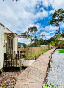 a wooden walkway leading to a house at Kireina Genting Villa in Genting Highlands