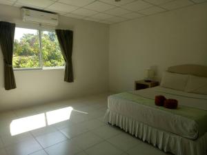 Postel nebo postele na pokoji v ubytování โรงแรมเวลลิงตัน