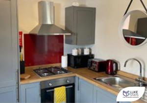 a kitchen with a sink and a stove top oven at Luke Stays - Alum Waters in New Brancepeth