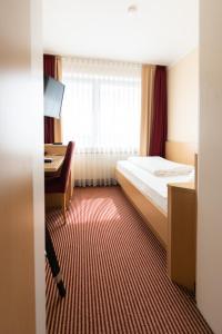 Postel nebo postele na pokoji v ubytování Europa Kehl Hotel
