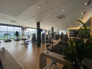 a gym with treadmills and machines in a building at Apartment Long Beach Iskele in Iskele