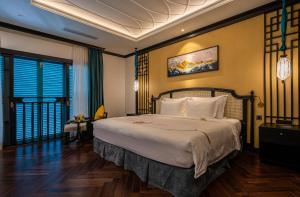 a bedroom with a large bed in a room at Potique Hotel in Nha Trang