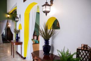 a room with a vase on a table with a lamp at Natural Park Resort Pattaya in Jomtien Beach