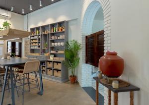 a dining room with an archway and a table and chairs at The Art Ghar in Jaipur