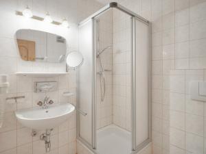 a bathroom with a shower and a sink at Center Rooms & Apartments in Mayrhofen