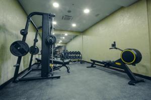 a gym with several tread machines in a room at Marjan Plaza Hotel in Tbilisi City