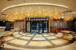 a large lobby with a large chandelier in the middle at Marjan Plaza Hotel in Tbilisi City