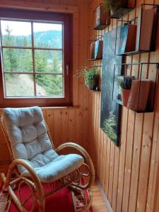 a room with a rocking chair and a window at Almhaus Kärnten Flattnitz in Flattnitz